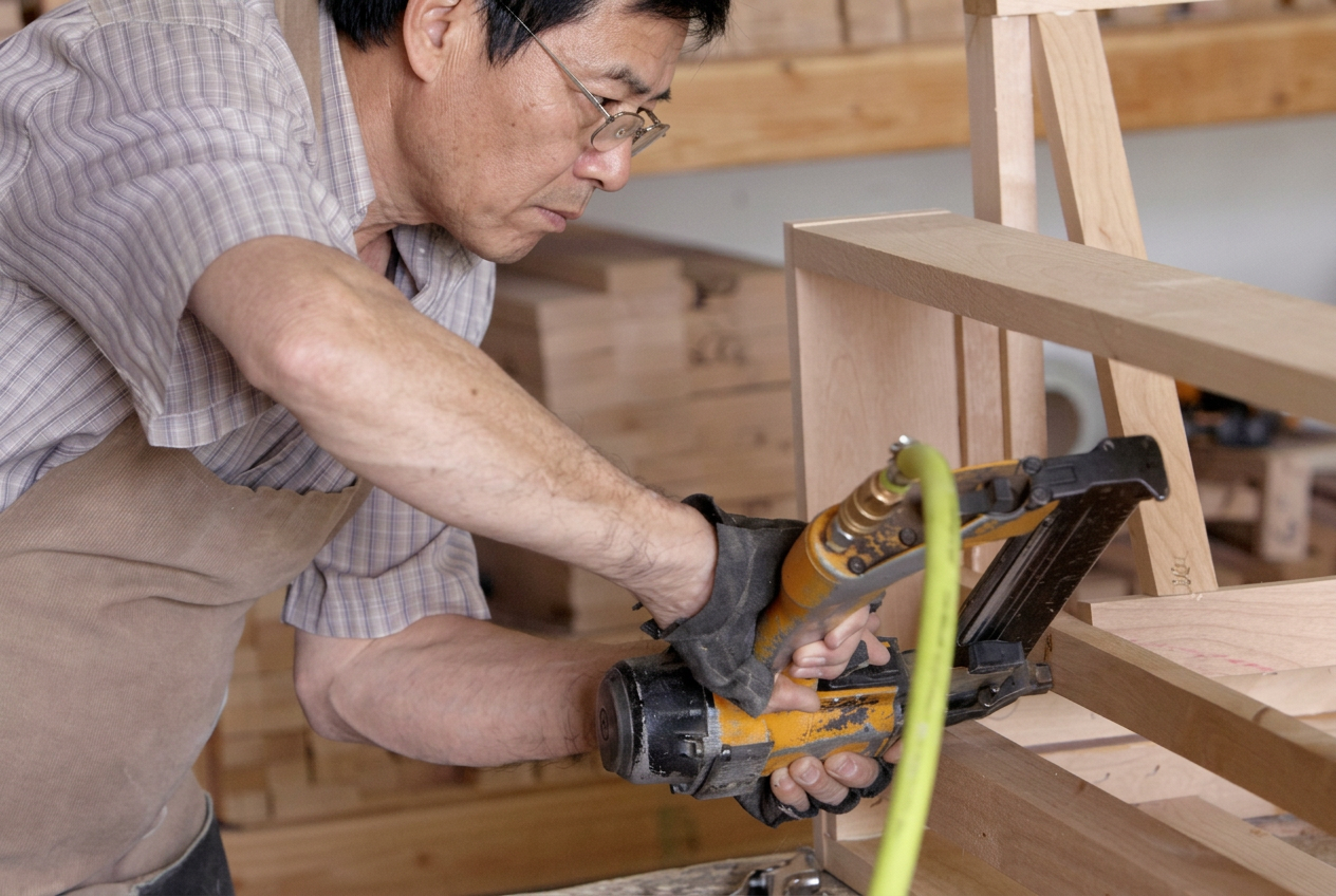 Craftsman building furniture frame in workshop